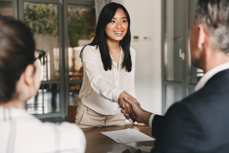 an mba student shaking hands with business owners