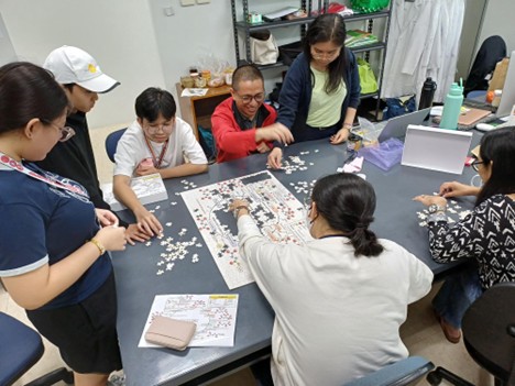 students and faculty completing a puzzle