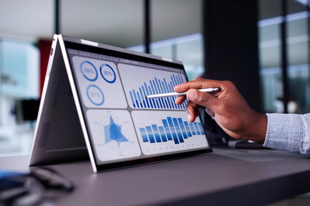 an accountant pointing at different data graphs shown on a tablet