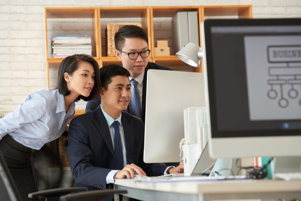 Business people working in office looking at a desktop