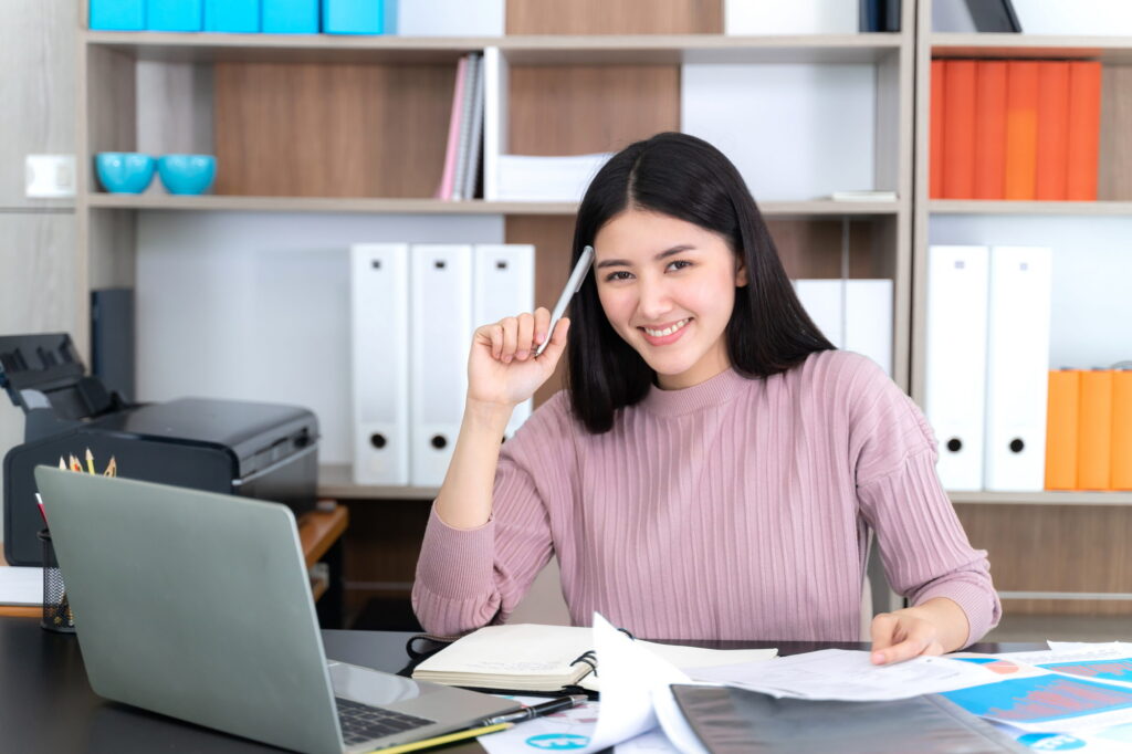 Young business woman using laptop computer on office desk